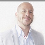 Passport picture of Alex Jeffreys in coat without tie