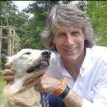 Terry Kyle in a passport photo holding his dog by the neck
